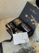 BLACK GOLD на пухнастому кріслі: відкрита чорна коробка з написом I was made for you і чорною стрічкою