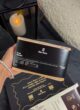 COFFEE MINI BLACK: рука з перлинним браслетом тримає пачку кави the box Brazil Santos