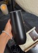 COFFEE MINI BLACK: матова чорна термочашка в руці над коробкою з шоколадом Lviv Handmade