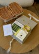 CALM & CARE на круглому столі поруч із плетеним кошиком і листівкою Happy Birthday