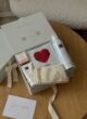 CUPID LOVE на круглому столі: відкрита коробка зі шкарпетками й маскою, поруч листівка Love you