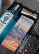 Бокс GIN MOMENT зблизька: пляшка Bombay Sapphire, коробка Snippers Gin з видом міста та металевий джигер
