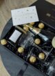 Бокс LIGHT UP: листівка Congratulations над келихами, свічкою та цукерками в коробці зблизька