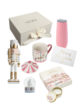 Бокс PINK X-MAS: коробка The Box, лускунчик, чашка, термочашка, снігова куля й листівка на білому тлі
