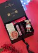 Бокс MOUSE GIFTS: чорна коробка з фігуркою мишки, шкарпетками, свічкою та косметикою Rituals на червоному тлі
