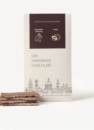 Шоколад молочний з кокосовою начинкою: біла упаковка Lviv Handmade Chocolate і шматочки плитки