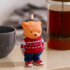 Свічка фігурна Christmas Bear 13 см: ведмедик у червоному светрі та джинсах на мармуровому столі